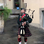 lone piper in the rain for the scottish week in barga italy