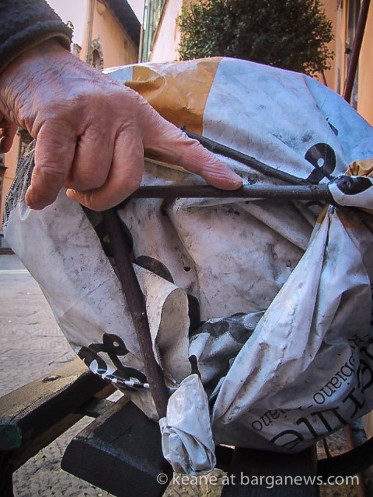 Plastic sack of charcoal and three sticks