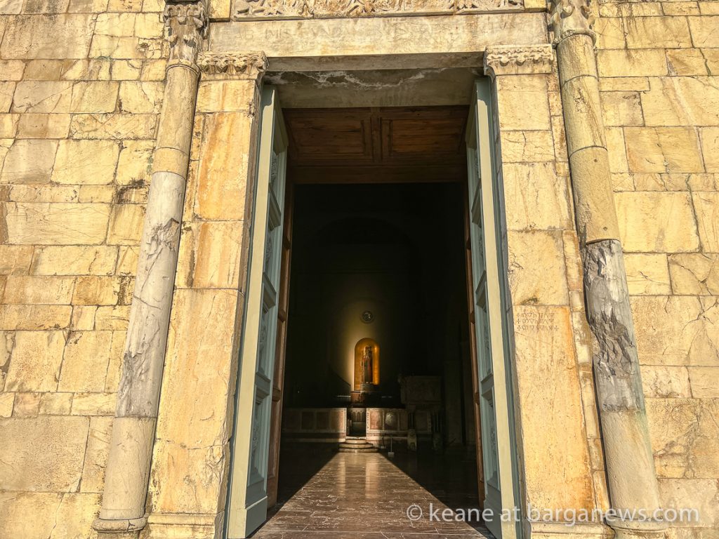 The sun illuminates the wooden statue of St. Christopher