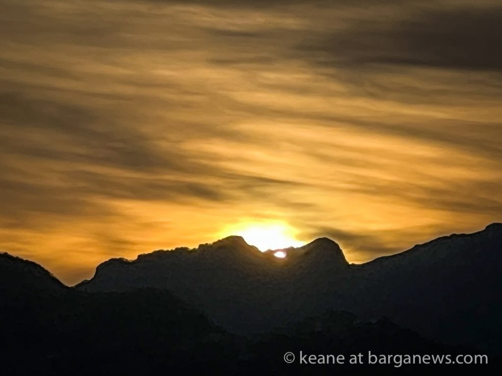 Double sunset obscured by clouds