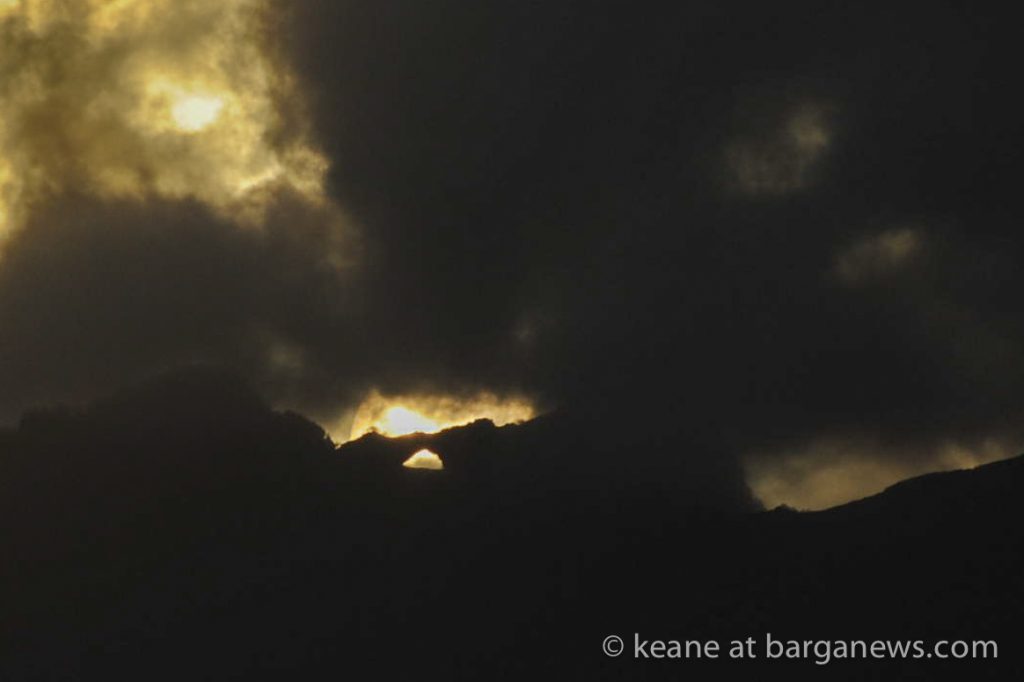 Double sunset obscured by clouds